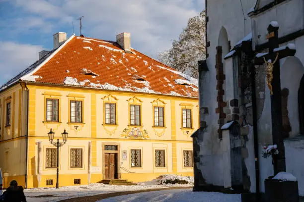 Narrow picturesque street with baroque and renaissance historical buildings in winter sunny day, beautiful cityscape of royal medieval town Pisek, Southern Bohemia, Czech Republic, January 09, 2021