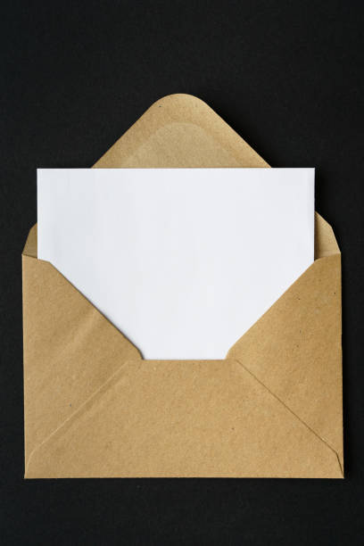 istock A brown envelope with a blank paper on a black background 1299249298