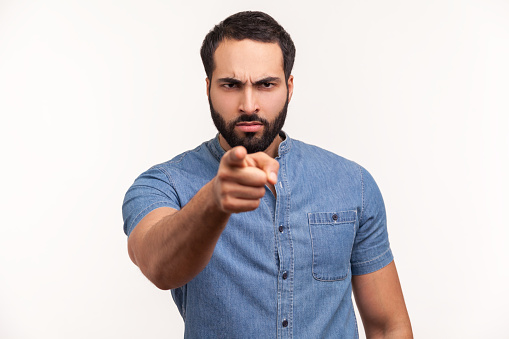 Are you ready? Serious bossy bearded man pointing finger at camera choosing you, scolding and forcing to move on. Indoor studio shot isolated on white background