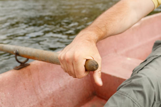 istock a man's hand holds on to the paddle while sailing on a boat 1299249721