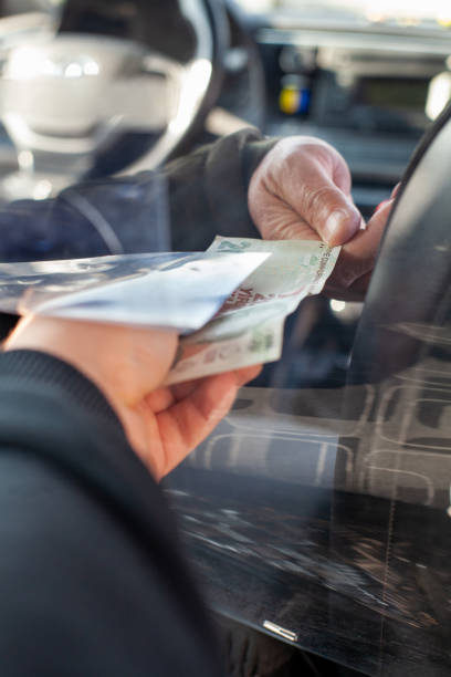 istock There are protective shields between the driver and the customers at the taxis. 1299250359