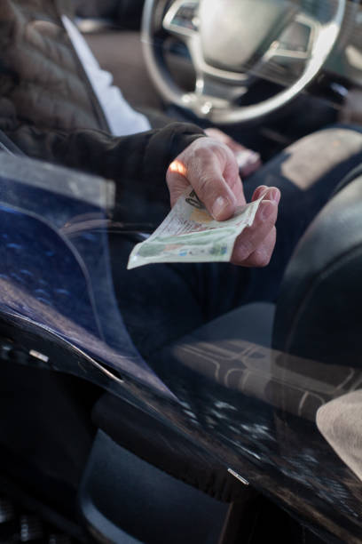 istock There are protective shields between the driver and the customers at the taxis. 1299250430