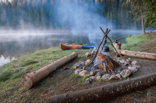 istock Campsite With Warming Place And Kayak Boats 1299252187