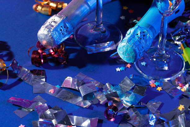 istock Champagne bottle on a purple background close up. Party concept 1299252246