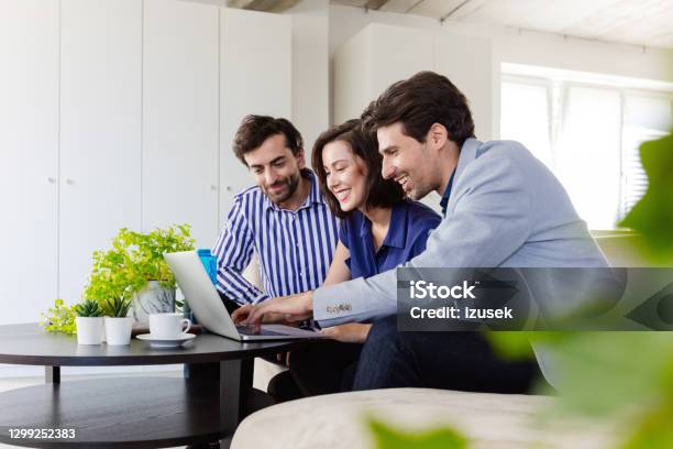 Business Team Discussing Project On Laptop Stock Photo - Download Image Now - Modern, Shareholder, Environmental Conservation