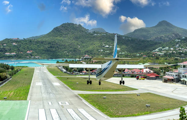 PLANE LANDING Plane landing in Saint Barthelemy famous airstrip french overseas territory stock pictures, royalty-free photos & images