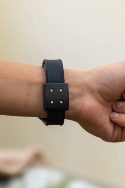 istock Back view of A COVID-19 positive tracking watch smart device for required patients for public safety, quarantine, and safety concepts. 1299254986