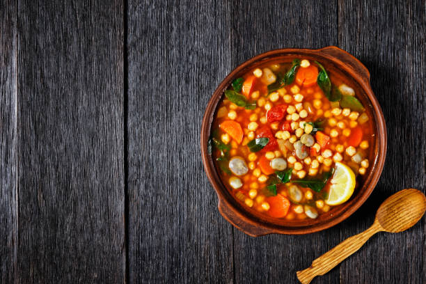 istock chickpea and green broad bean Moroccan soup in an earthenware bowl on a rustic wooden table, flat lay 1299255040