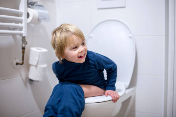 Cute toddler boy, sitting on toilet Cute toddler boy, sitting on toilet, smiling potty toilet child bathroom stock pictures, royalty-free photos & images