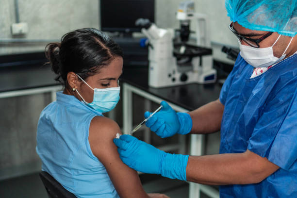 Young woman receiving coronavirus vaccine Hispanic woman receiving coronavirus vaccine colombia photos stock pictures, royalty-free photos & images