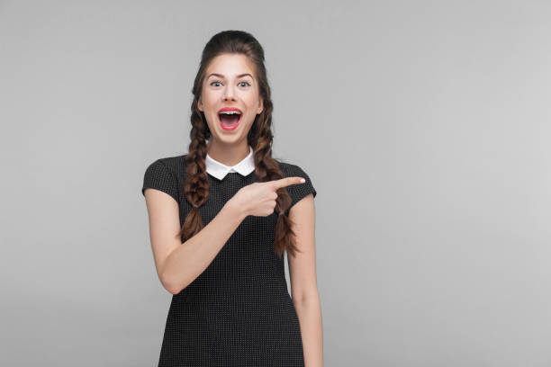 istock Happiness woman pointing finger at copy space. 1299256025