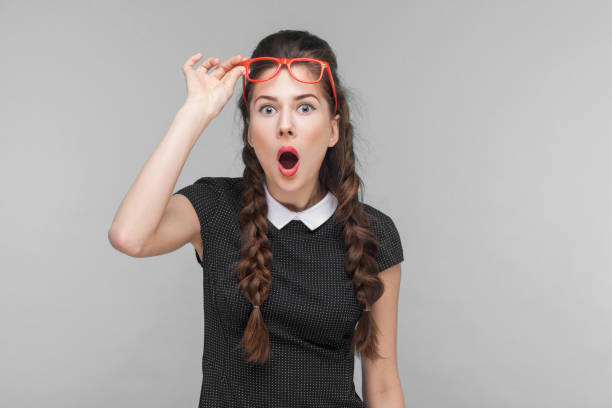 istock Surprised woman in red glasses amazement looking at camera 1299256044