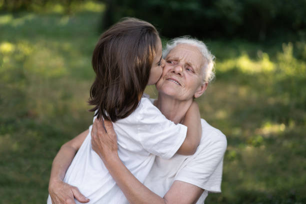 istock Affectionate granddaughter and grandmother are hugging. 1299256761