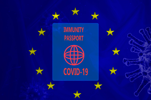 Immune passport on background of EU flag. Certificate confirms vaccination against covid-19. Vaccination document due to covid-19.