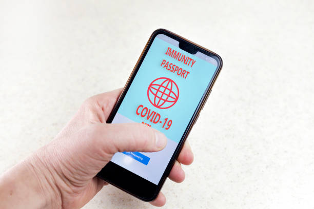 istock Certificate confirms vaccination against covid-19. Vaccination document due to covid-19 on a smartphone. 1299256871