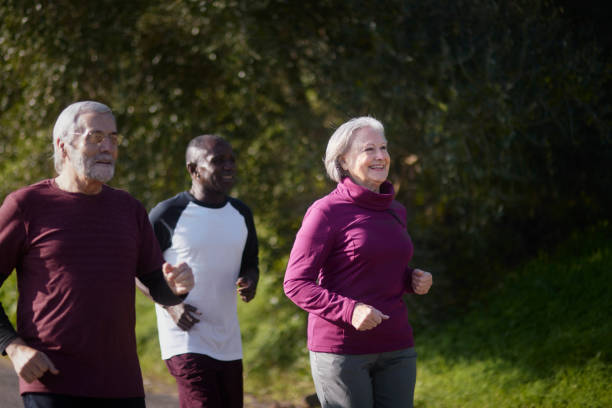 istock Group of seniors running together on outdoors park 1299257600