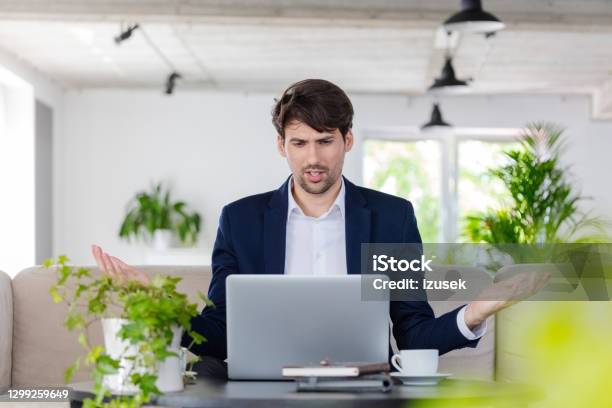 Businessman During Video Conference Stock Photo - Download Image Now - Displeased, Video Conference, 30-39 Years