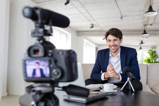 istock Businessman making a video blog in the office 1299260683