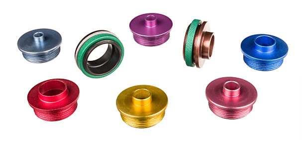Colorful copying rings and green nuts for wood milling. Woodworking tool accessory with colored anodizing surface finish