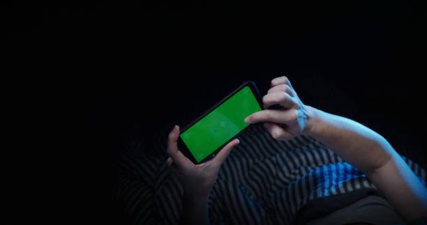 istock Mature woman is using phone in bed 1299262026