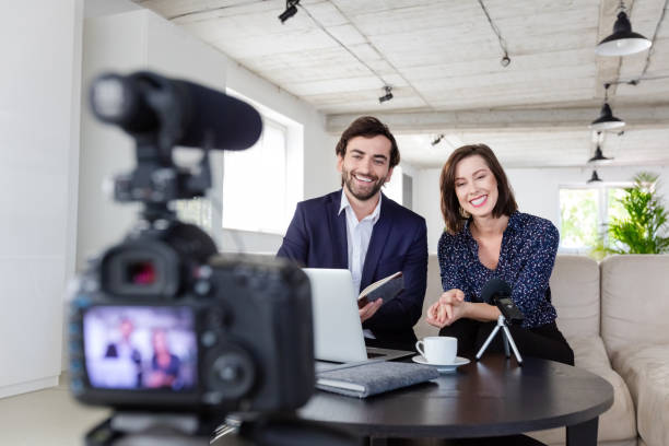 istock Coworkers making a video blog in the office 1299264105
