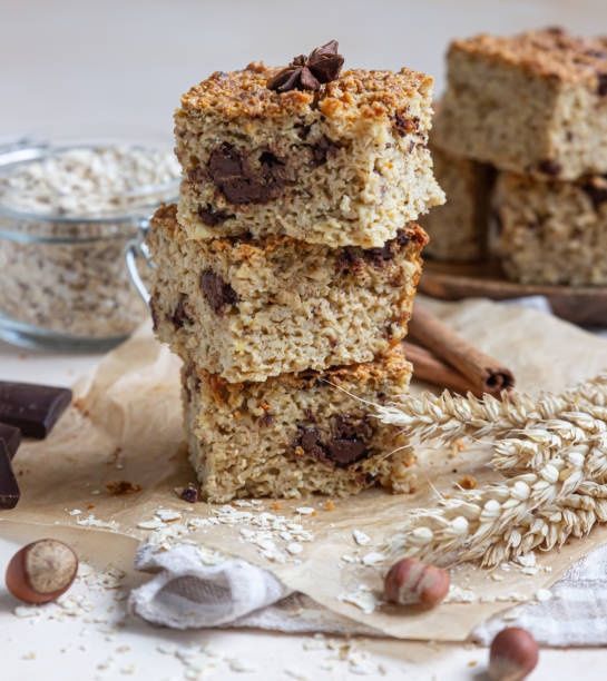 istock Oatmeal squares with chocolate, light concrete background. Diet bars. Healthy bakery for breakfast or dessert. 1299264444