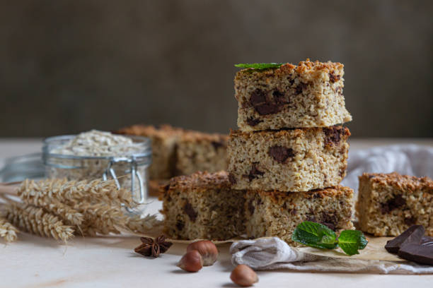 istock Oatmeal squares with chocolate decorated with mint, light concrete background. Diet bars. Healthy bakery for breakfast or dessert. 1299264632
