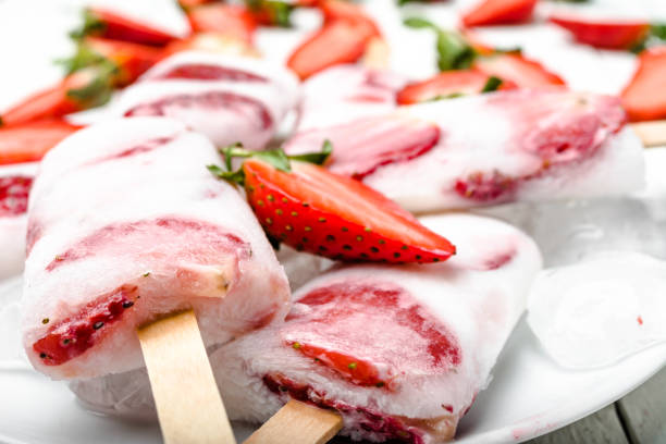 istock Natural juicy strawberry popsicles with yogurt. Refreshing ice pops, closeup 1299265498