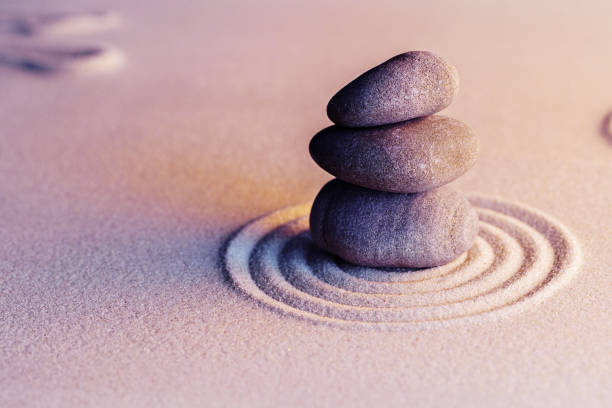 istock Zen garden stones on sand with ornament 1299268263