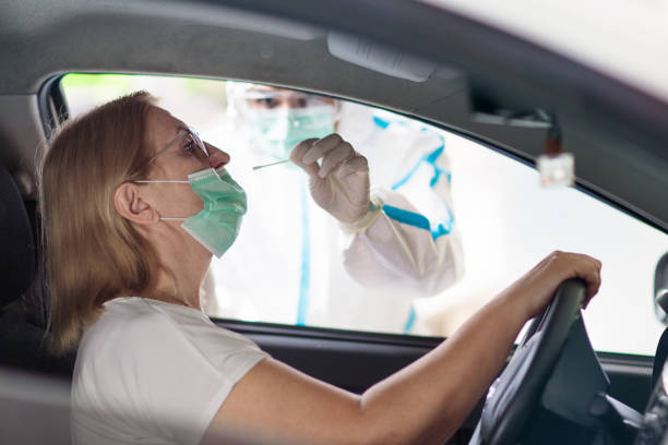 istock Coronavirus swab test. Doctor and Covid-19 patient 1299271575