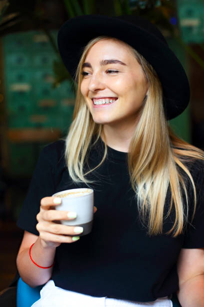istock Cheerful woman enjoying coffee in cafe 1299271732