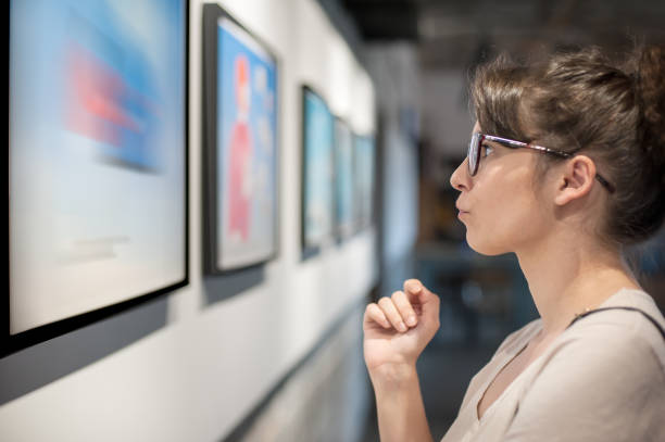 istock Young woman in modern art exhibition gallery hall 1299273158