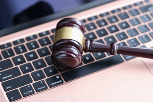 istock Judges hammer lying on laptop keyboard in courthouse closeup 1299273733