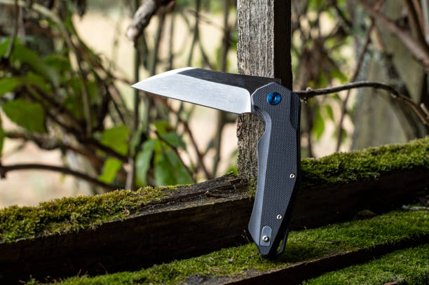 istock A sharp knife in a bent position. Knife on the background of a bush. 1299275848