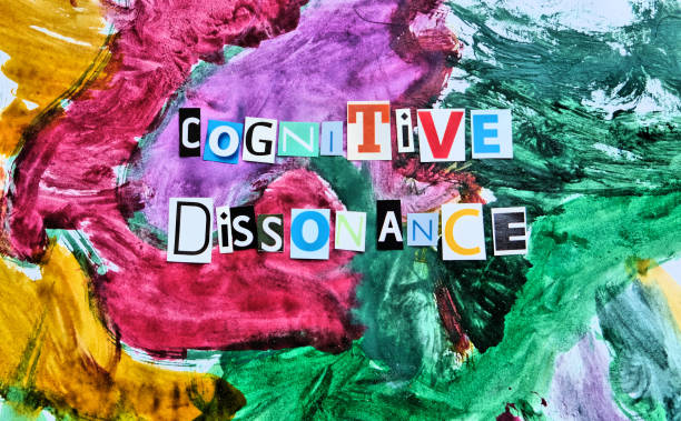 istock cognitive dissonance  text from  cut  letters on abstract strokes colorfull background. Headline - Cognitive dissonance, card of psychology . Psychologic concept. 1299276135