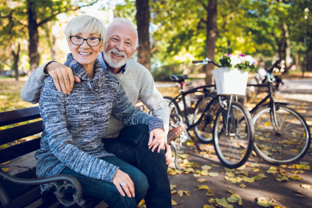 istock Senior couple relaxing on bench in the park 1299276229