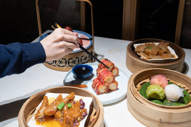istock A hand taking the Guangdong dum sum named Red Shrimp Chee Cheong Fun with chopsticks 1299279643