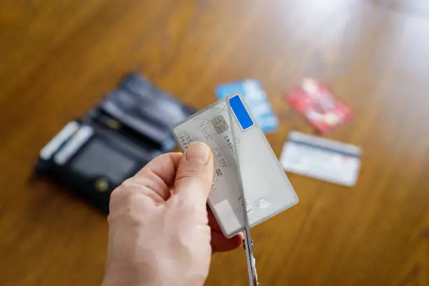 Photo of Irreversible destruction of a deactivated payment card by cutting with scissors