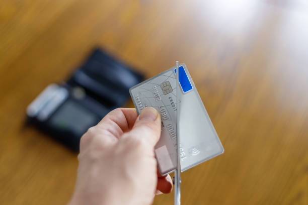 istock Irreversible destruction of a deactivated payment card by cutting with scissors 1299280989