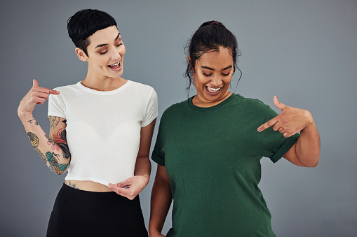 Shot of two young women showing off their blank t-shirts