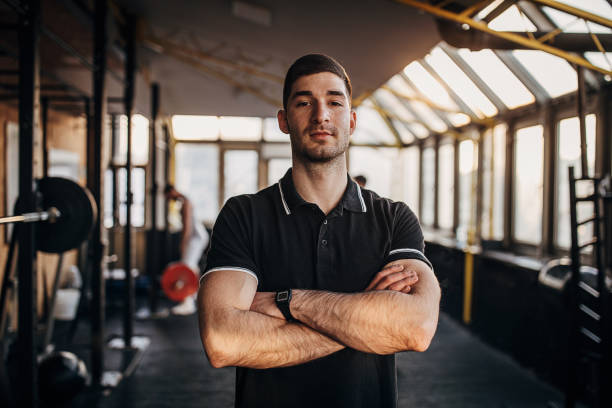 istock Muscular man standing alone in gym 1299281822