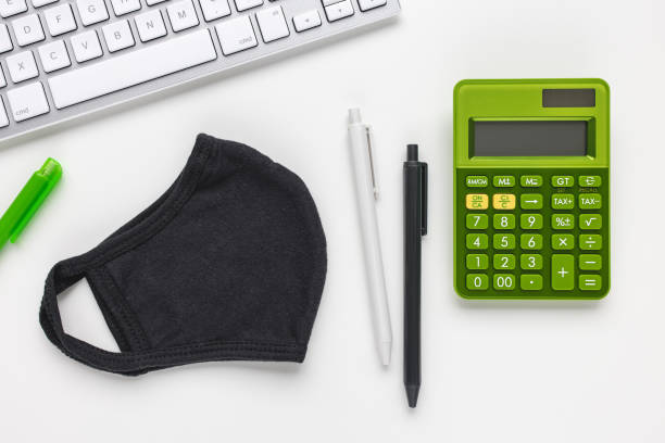 istock Mask, keyboard and calculator. Tax return concept 1299282655