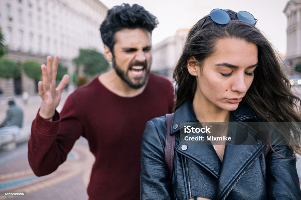 Couple in relationship difficulties Bearded man shouting at his girlfriend Toxic - Social Concept Stock Photo