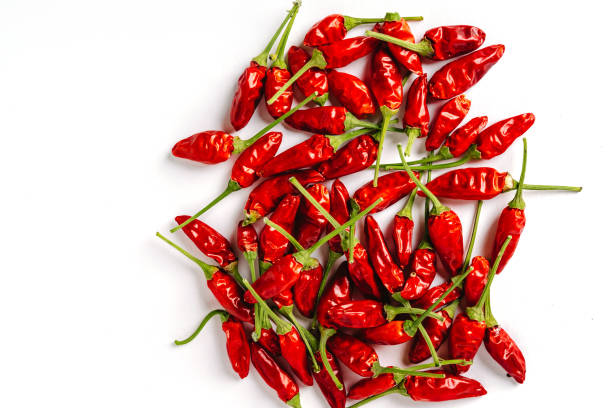 istock Red chili peppers spread out on a white background, vegetable pattern 1299284453