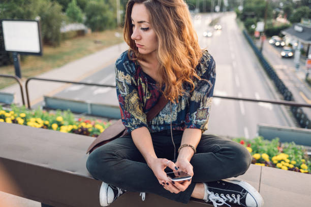 istock Girl sitting on a bridge and feel lonely 1299284454