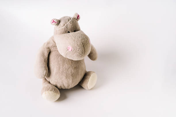 istock Plush stuffed toy hippo sits on a white background 1299285044