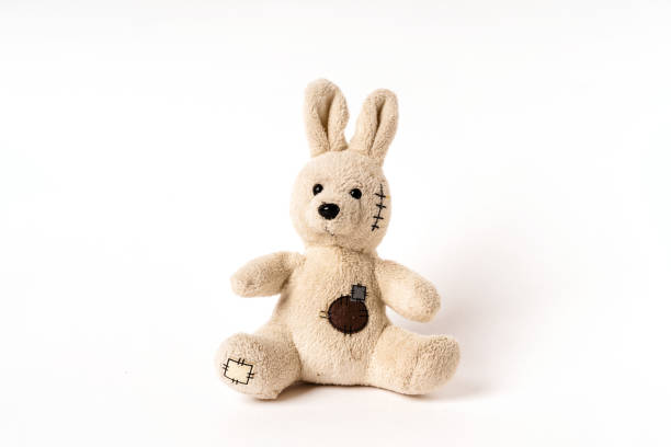 istock Plush stuffed rabbit toy sitting on white background 1299285056