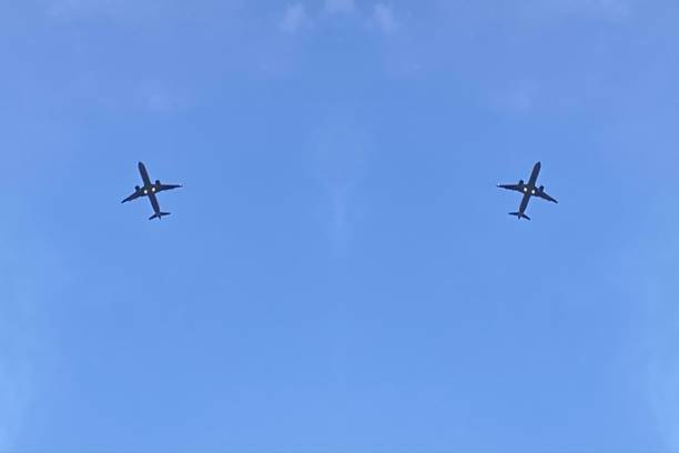 istock Passenger aircrafts flying in blue sky 1299286600