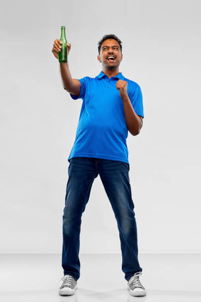 istock indian  male fan with beer bottle celebrating victory 1299288050