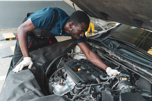 Portrait of African professional staff working on maintenance inspection in the auto services tires services center